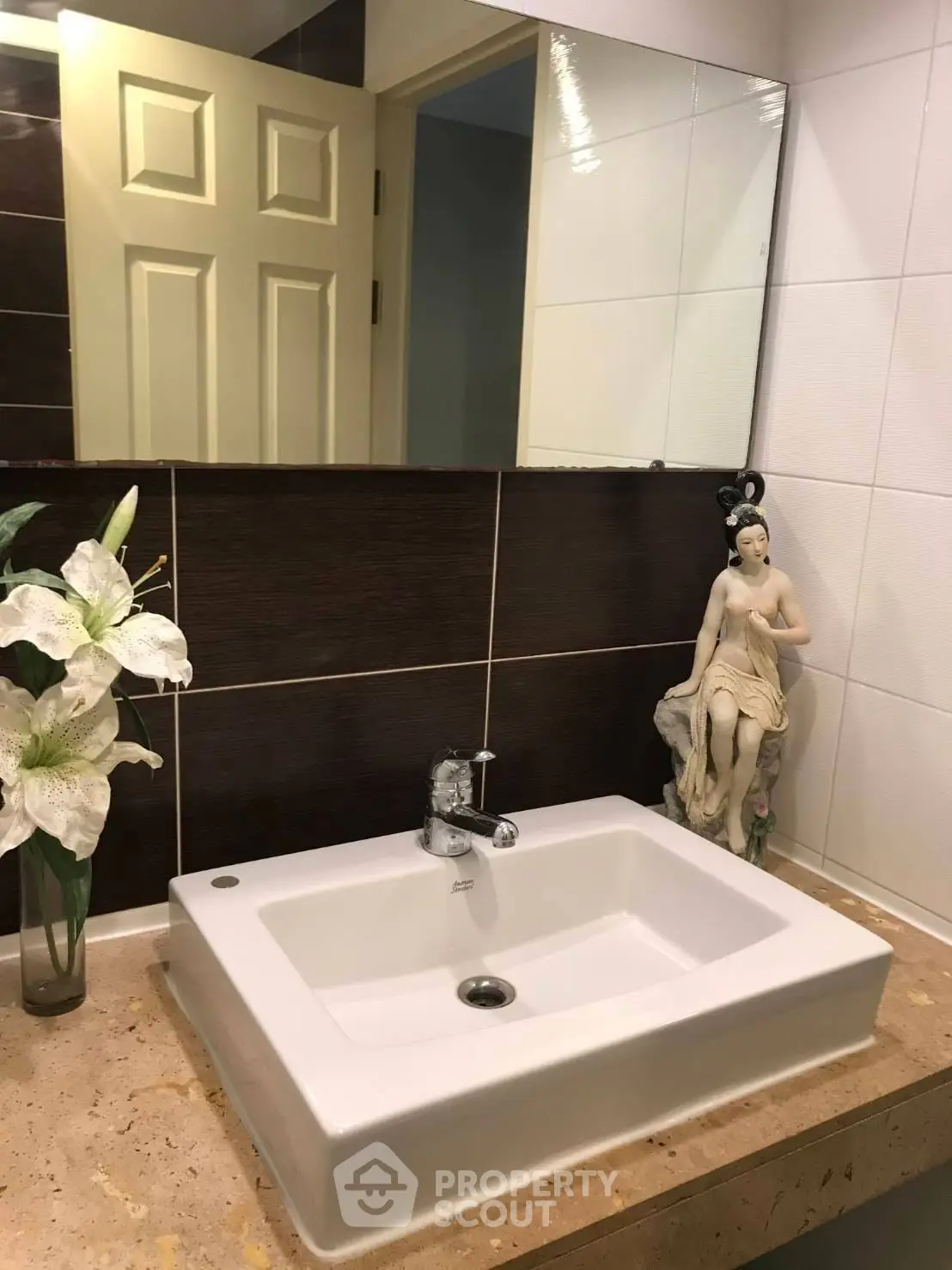 Elegant bathroom with modern sink and decorative statue