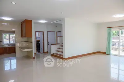 Spacious open-plan living area with modern kitchen and natural light