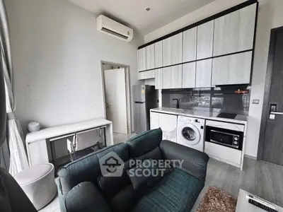 Modern compact living room with integrated kitchen and washing machine