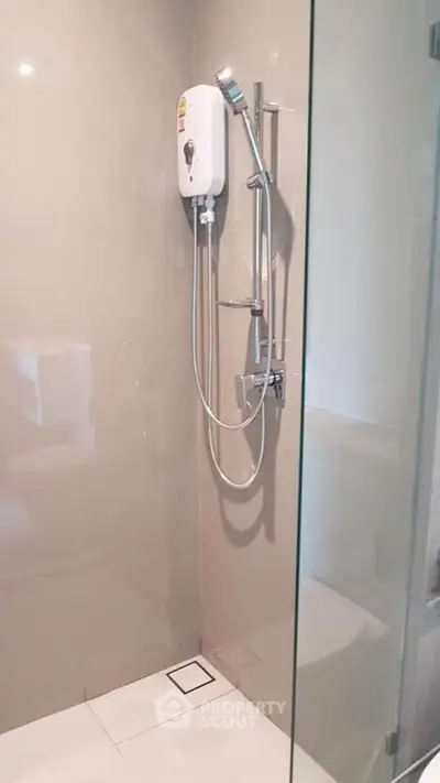 Modern bathroom with sleek shower and glass enclosure in contemporary home.