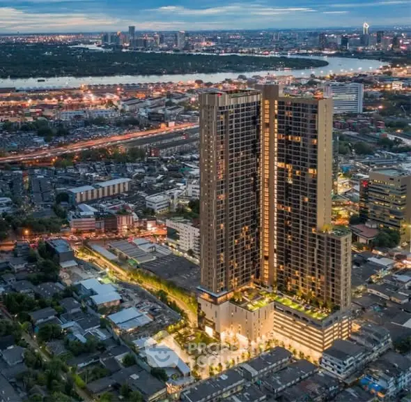 Stunning aerial view of modern high-rise building in vibrant urban setting at dusk.