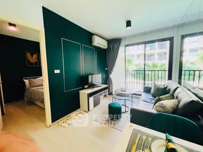 Modern living room with stylish decor and balcony view in a contemporary apartment.
