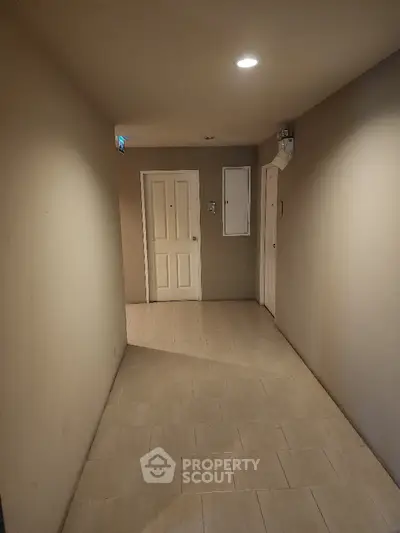 Spacious and well-lit entryway with neutral tones and tiled flooring, offering a welcoming entrance to a modern home.