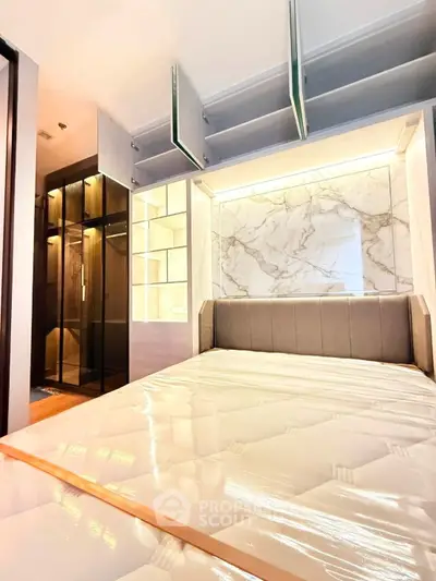 Luxurious bedroom with marble accent wall and built-in storage in modern apartment