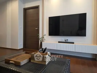 Modern living room with wall-mounted TV and stylish wooden decor