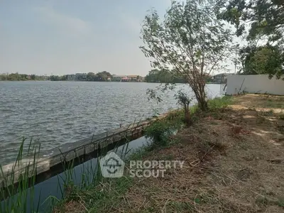 Scenic waterfront view with lush greenery and serene surroundings, perfect for tranquil living.