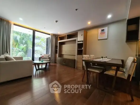 Spacious living room with elegant wooden flooring and modern furniture