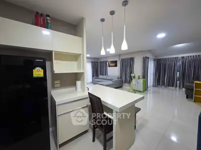 Spacious modern living room with open kitchen and stylish lighting