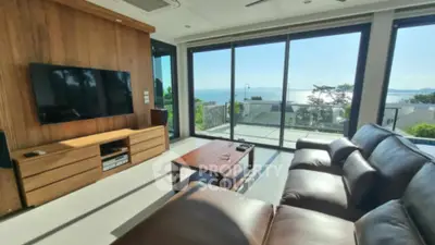 Luxurious living room with stunning ocean view and modern leather sofa.