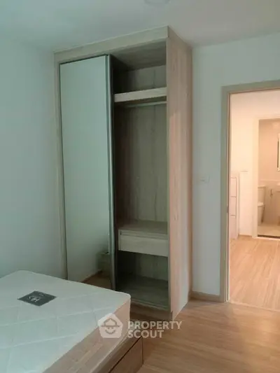 Modern bedroom with wooden flooring and built-in wardrobe