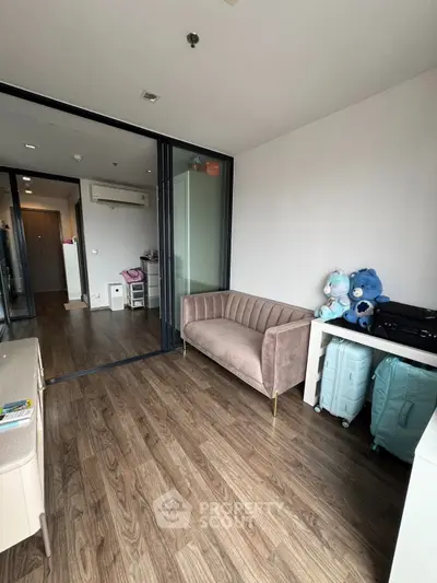 Modern apartment interior with stylish sofa and wooden flooring, featuring a cozy and inviting atmosphere.