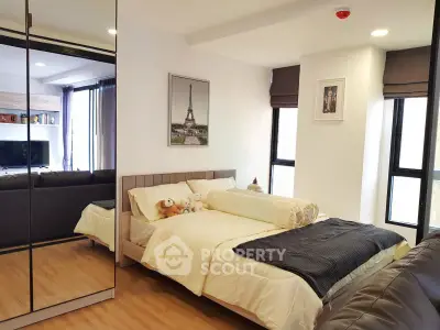 Modern bedroom with mirrored wardrobe and cozy decor in stylish apartment