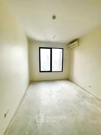 Spacious empty room with large window and city view, perfect for customization.