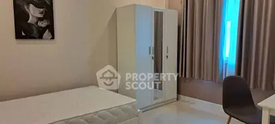 Modern bedroom with minimalist design featuring a bed, wardrobe, and desk, ideal for urban living.