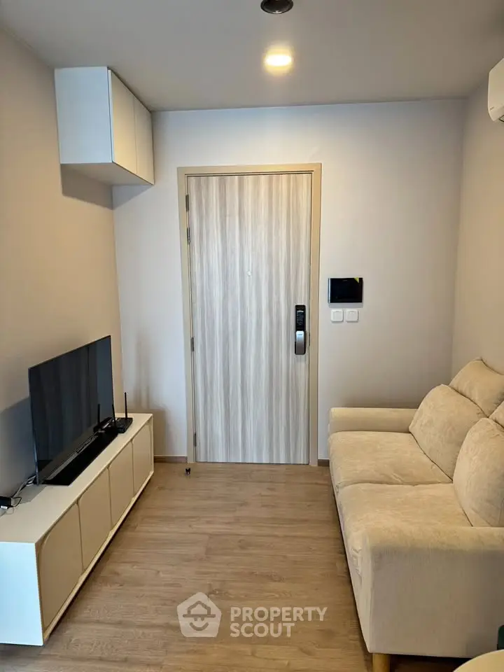 Cozy living room with modern decor and comfortable seating in a stylish apartment.