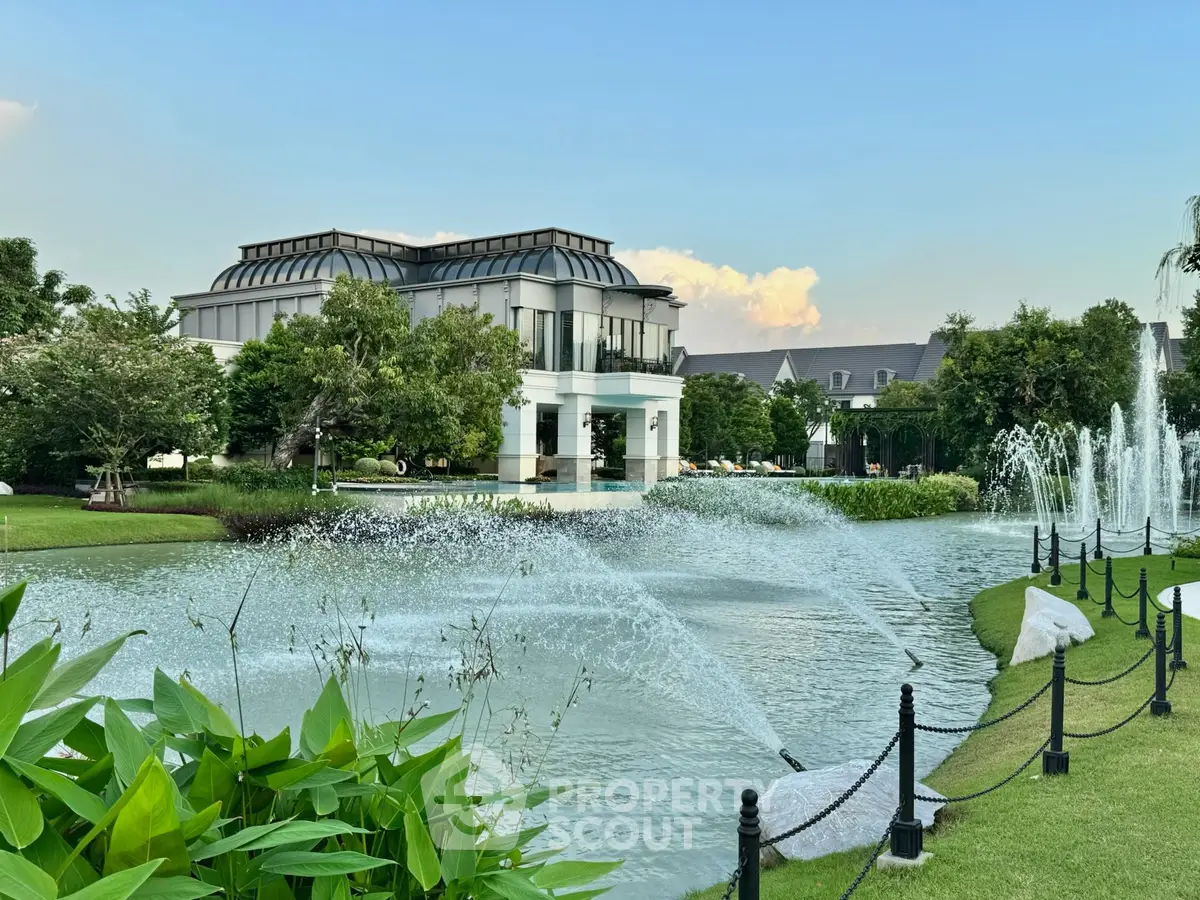 Luxurious estate with stunning water feature and lush landscaping