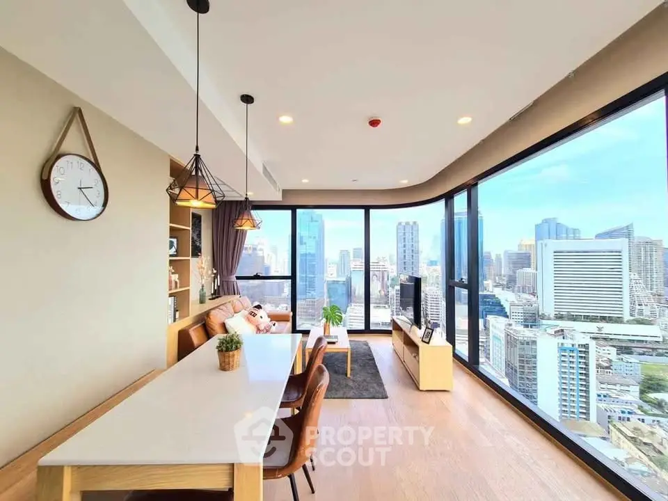 Stunning corner unit living room with panoramic city views and modern decor.