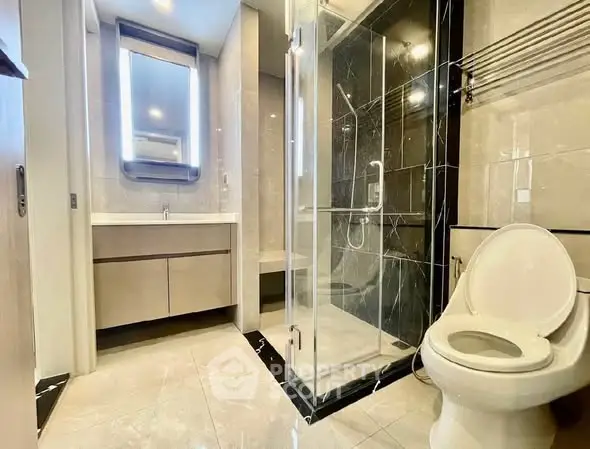 Luxurious modern bathroom with glass shower and elegant fixtures