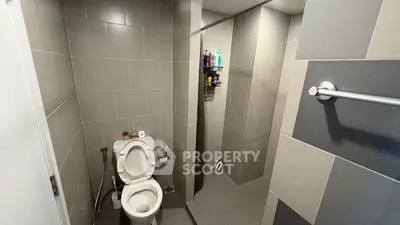 Modern bathroom with sleek gray tiles and open shower design