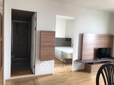 Modern apartment interior with bedroom and living area featuring wooden accents and natural light.