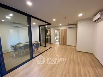 Spacious modern living room with glass partition and dining area