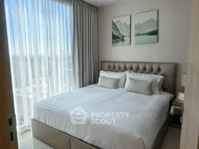 Luxurious bedroom with large window and elegant decor in modern apartment