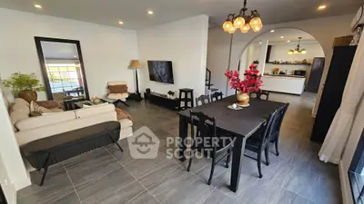 Spacious modern living room with elegant dining area and open kitchen layout, perfect for family gatherings.