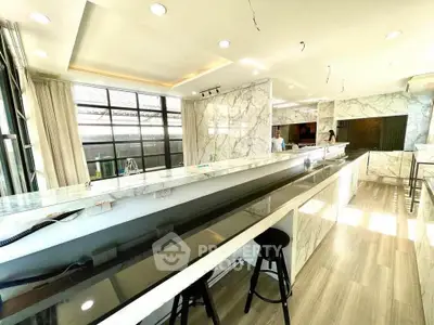 Luxurious modern kitchen with marble countertops and ample natural light