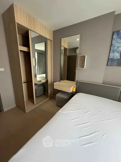Modern bedroom with sleek design and built-in wardrobe in a stylish apartment.