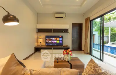 Modern living room with pool view, stylish decor, and entertainment setup.