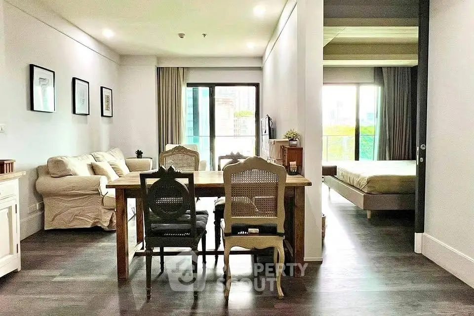 Spacious open-plan living and dining area with natural light and modern furnishings.