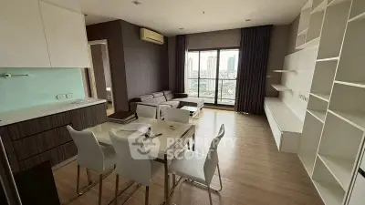 Modern living room with city view, featuring sleek furniture and open layout for stylish urban living.