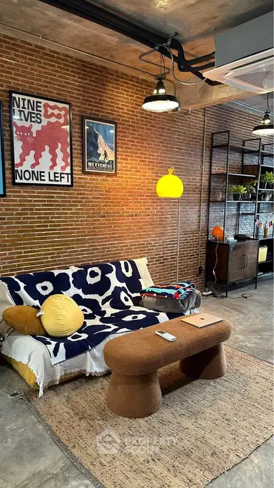 Stylish industrial living room with exposed brick wall and modern decor