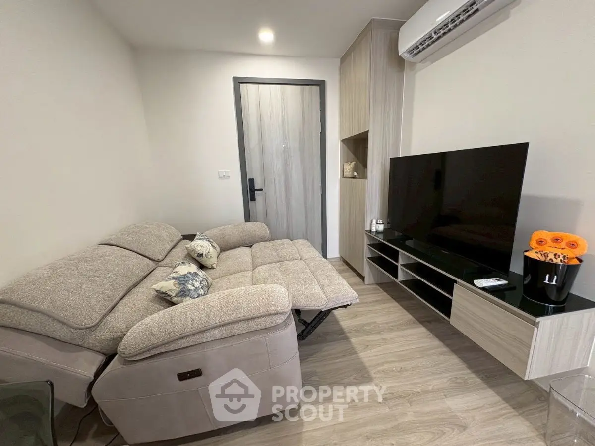 Modern living room with cozy sofa and sleek entertainment center