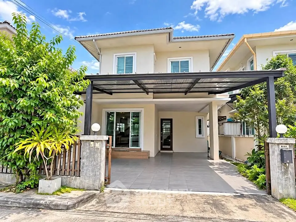 Charming two-story house with spacious driveway and lush greenery, perfect for family living.