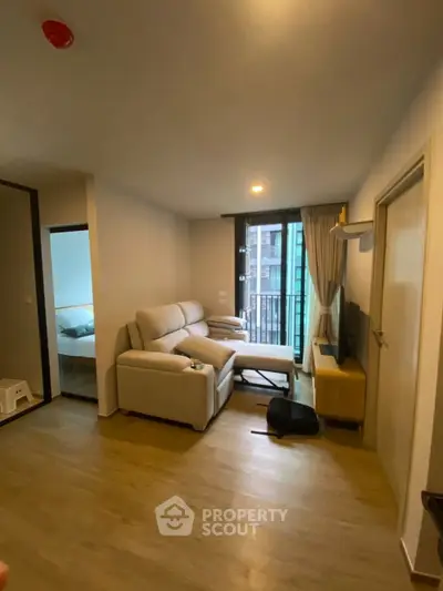 Modern living room with cozy sofa and balcony view in stylish apartment
