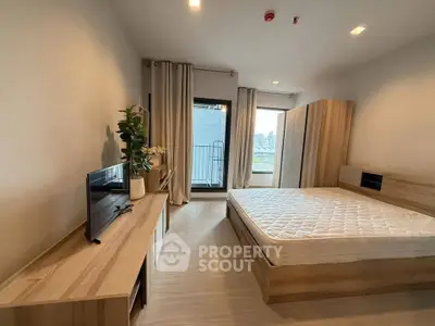 Modern bedroom with balcony access and stylish wooden furniture