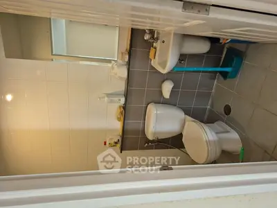 Compact bathroom with modern fixtures and neutral tiles