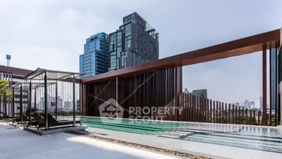 Luxurious rooftop pool with stunning city skyline views in modern high-rise building.