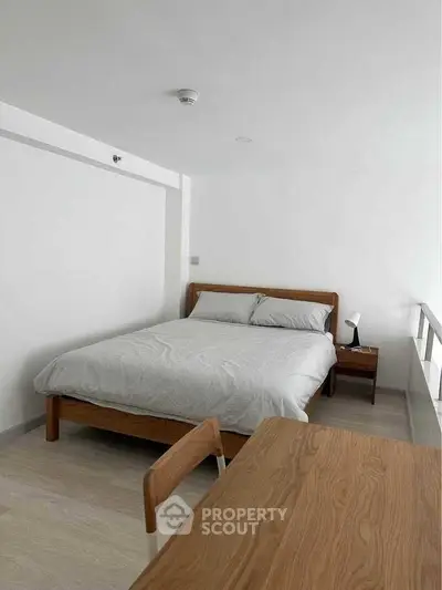 Modern minimalist bedroom with wooden furniture and natural light