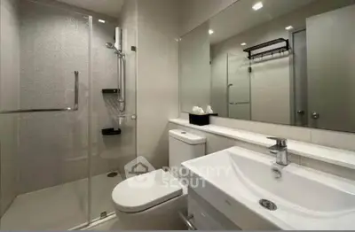 Modern bathroom with sleek design, glass shower, and elegant fixtures in a contemporary home.