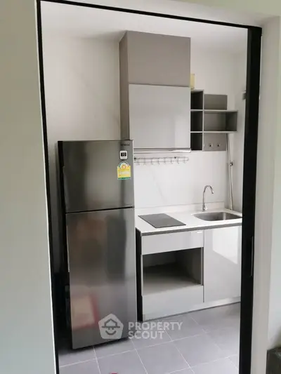 Modern compact kitchen with sleek appliances and minimalist design