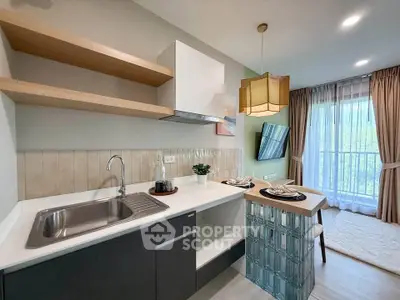 Modern kitchen with open layout and stylish dining area, featuring large windows and elegant decor.