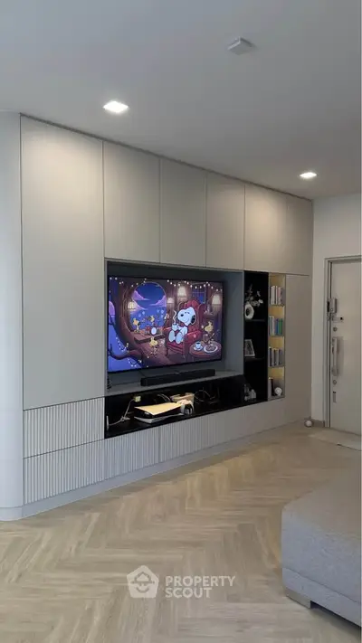 Modern living room with built-in entertainment center and cozy decor