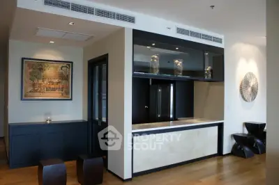 Modern living room with stylish decor and open layout, featuring elegant wood flooring and contemporary art pieces.