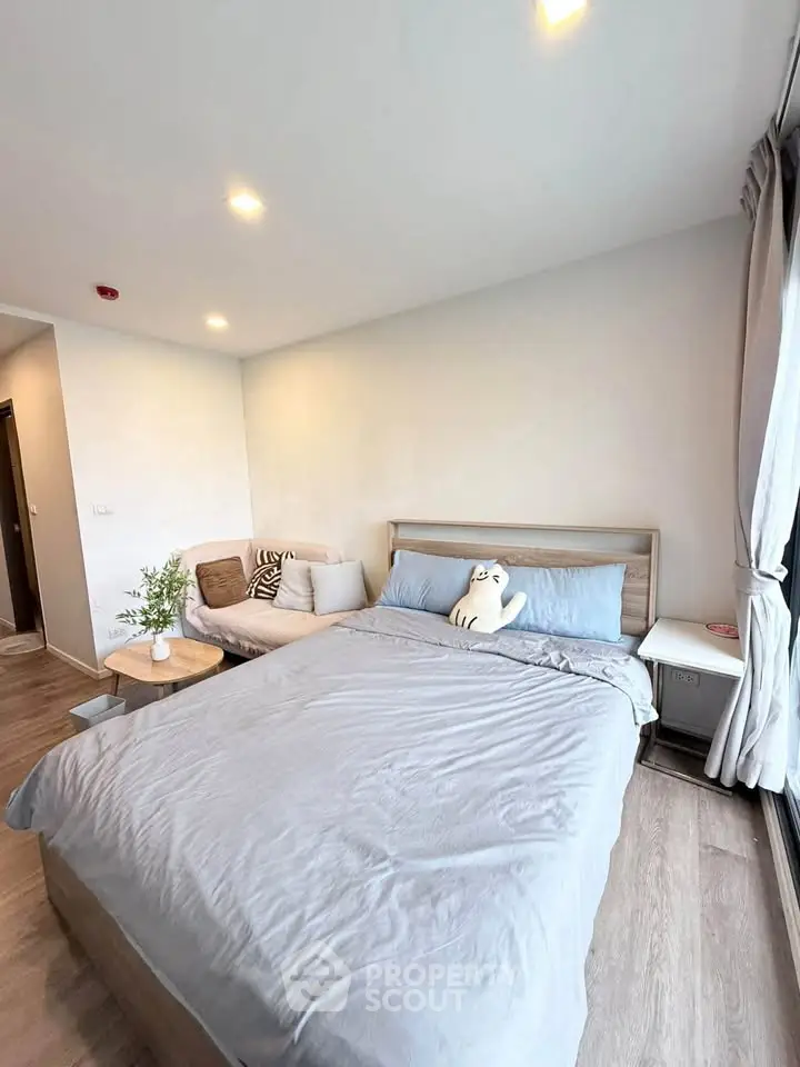 Modern bedroom with cozy bed and natural light in stylish apartment