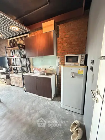 Modern industrial kitchen with exposed brick and sleek appliances