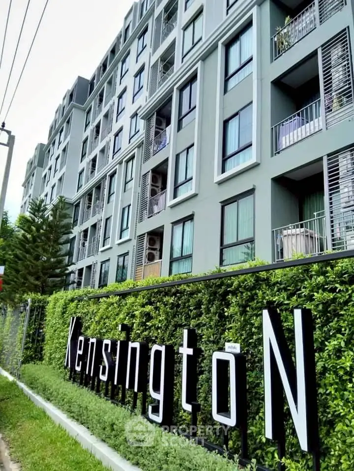 Modern apartment building with lush greenery and stylish facade