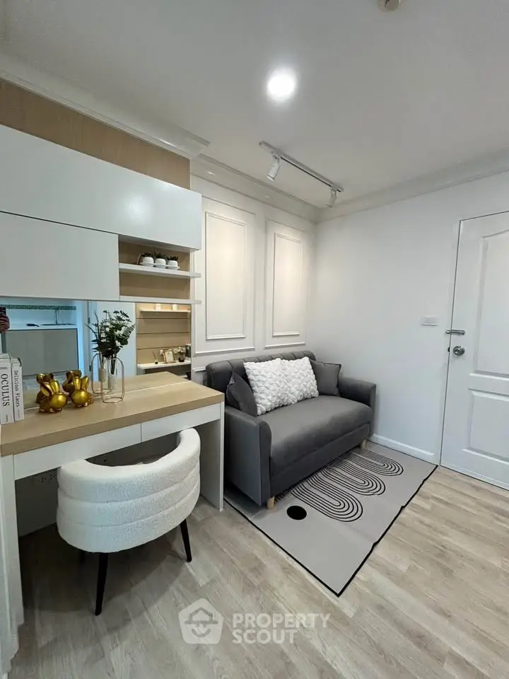 Chic modern living room with stylish decor and cozy seating in a compact space.