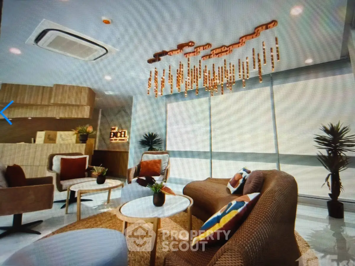 Luxurious modern living room with stylish furniture and unique chandelier, perfect for relaxation and entertainment.